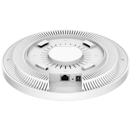 Na zdjęciu znajduje się biały, okrągły access point z widocznymi portami na tylnej stronie. Urządzenie ma nowoczesny design z perforowanymi elementami na obwodzie.