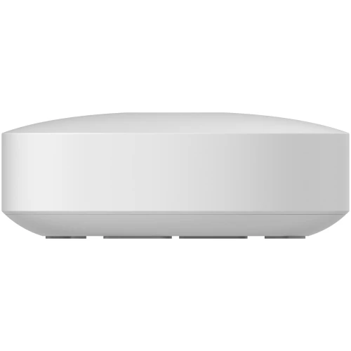 Na zdjęciu znajduje się biała, prostokątna bramka domowa z zaokrąglonymi krawędziami, umieszczona na białym tle. Urządzenie ma minimalistyczny design i jest widoczne z boku.