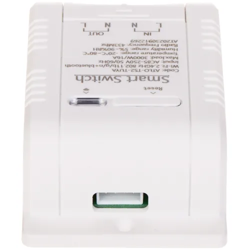 Zdjęcie przedstawia biały moduł Smart Switch z widocznymi oznaczeniami technicznymi na obudowie. Na dole urządzenia znajduje się zielone złącze do podłączenia przewodów.